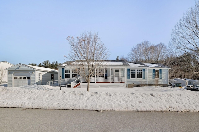 view of front facade with covered porch and a detached garage