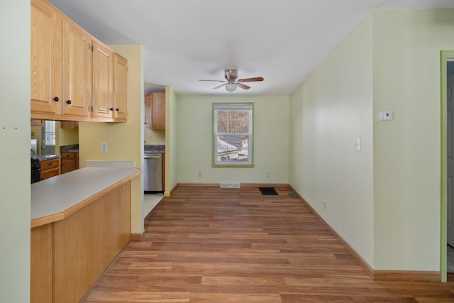 kitchen featuring visible vents, a ceiling fan, dishwasher, light brown cabinetry, and light wood-type flooring