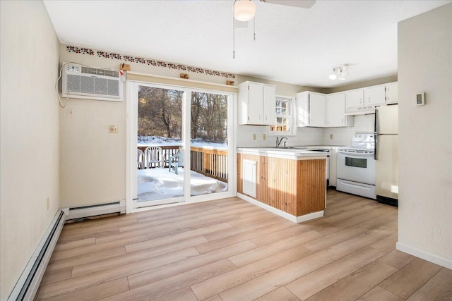 kitchen with white appliances, decorative backsplash, light countertops, an AC wall unit, and light wood-style floors