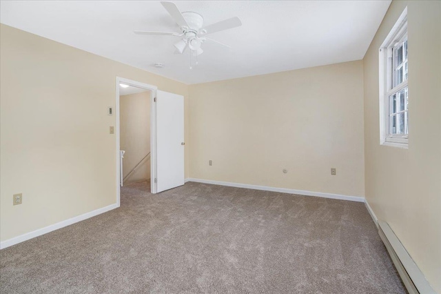 spare room featuring ceiling fan, carpet flooring, and baseboards