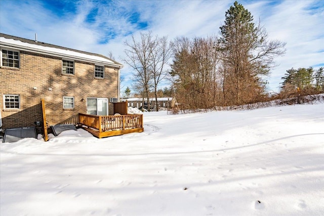 yard layered in snow featuring a wooden deck