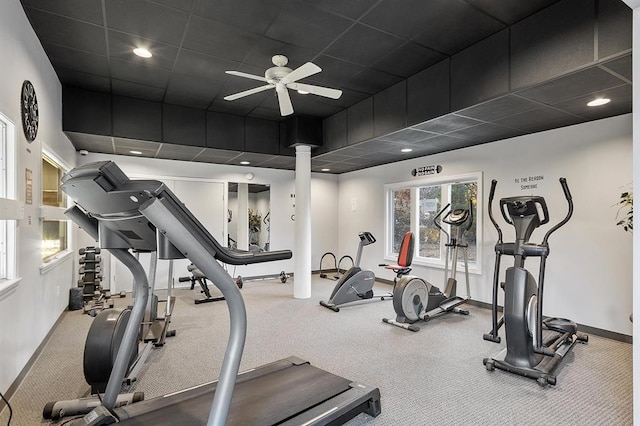 exercise room featuring a drop ceiling, ceiling fan, and baseboards