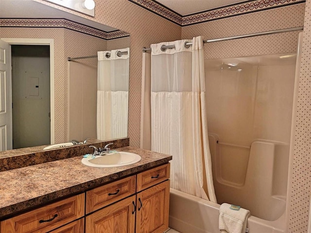 full bath with wallpapered walls, shower / tub combo with curtain, and vanity