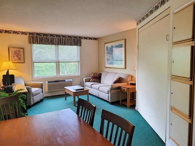 living room featuring a textured ceiling, carpet flooring, and a wall mounted AC