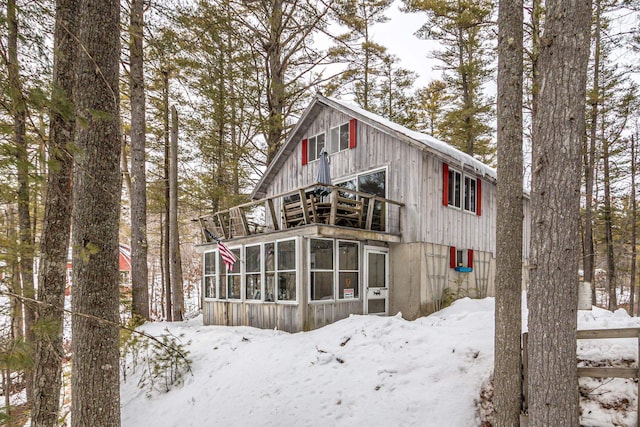 exterior space with a balcony and a sunroom