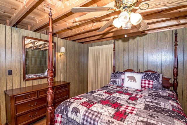 bedroom with beam ceiling and wood walls