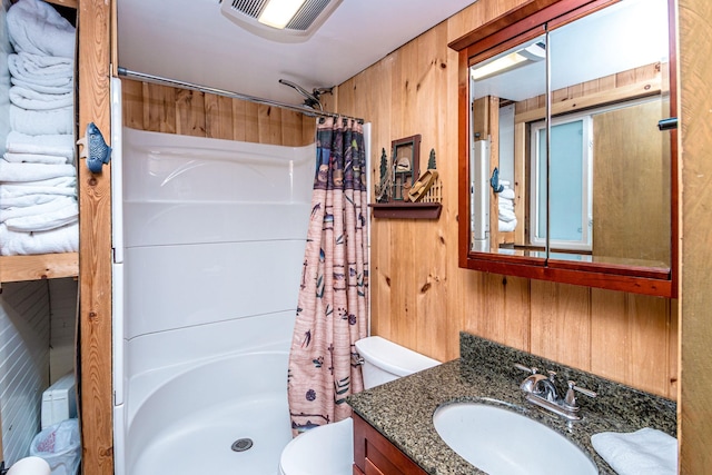 full bathroom with wooden walls, visible vents, toilet, a shower with shower curtain, and vanity