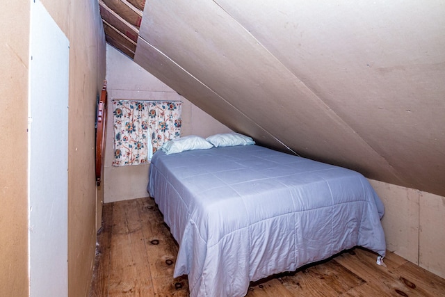 bedroom featuring lofted ceiling and wood-type flooring