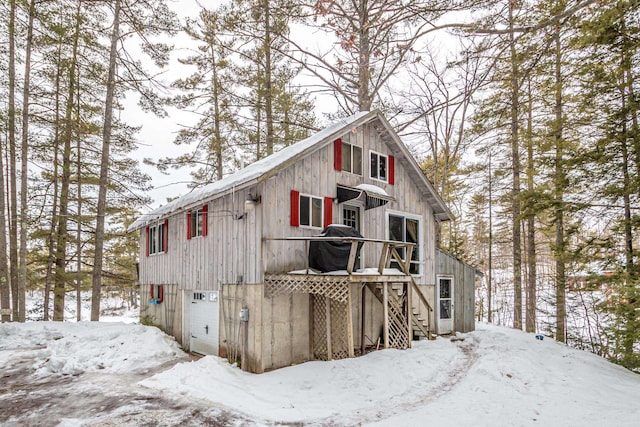 exterior space featuring a garage and stairs