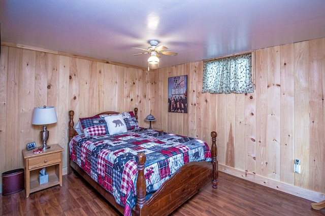 bedroom with wood walls, baseboards, a ceiling fan, and wood finished floors