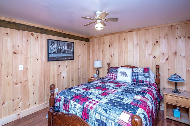 bedroom featuring ceiling fan, wood finished floors, and wood walls