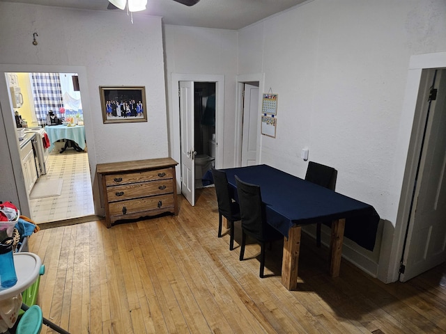 dining room with ceiling fan and light wood finished floors