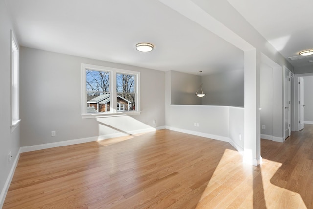 unfurnished room featuring light wood-type flooring and baseboards