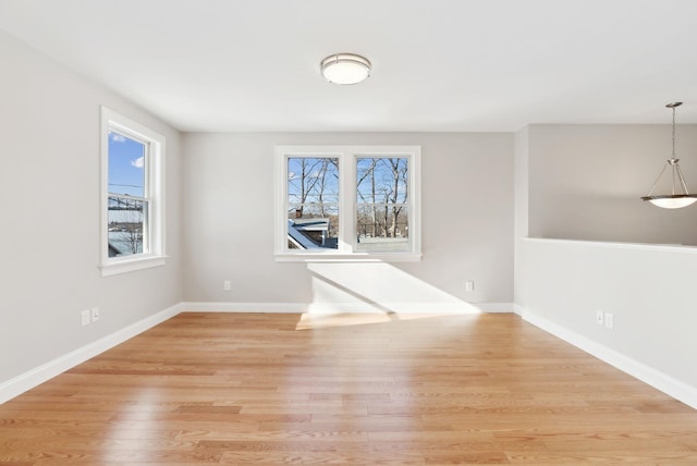 unfurnished room featuring light wood-style flooring and baseboards