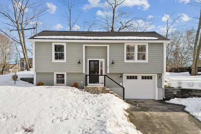 bi-level home featuring a garage and driveway