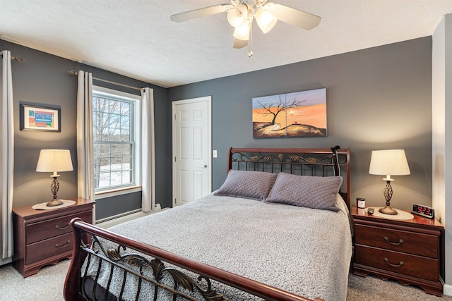 bedroom with light carpet, ceiling fan, and a textured ceiling