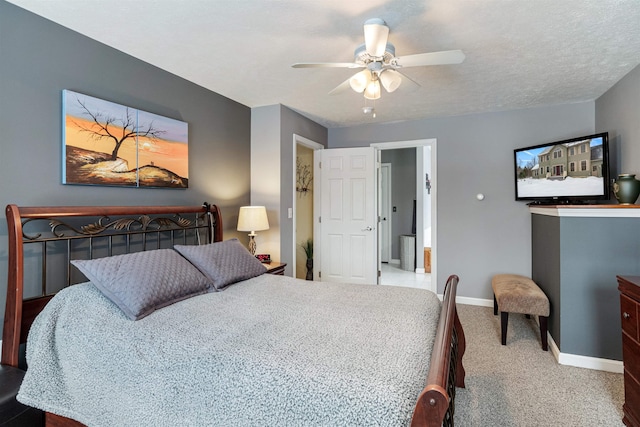 bedroom featuring ceiling fan, a textured ceiling, baseboards, and carpet flooring