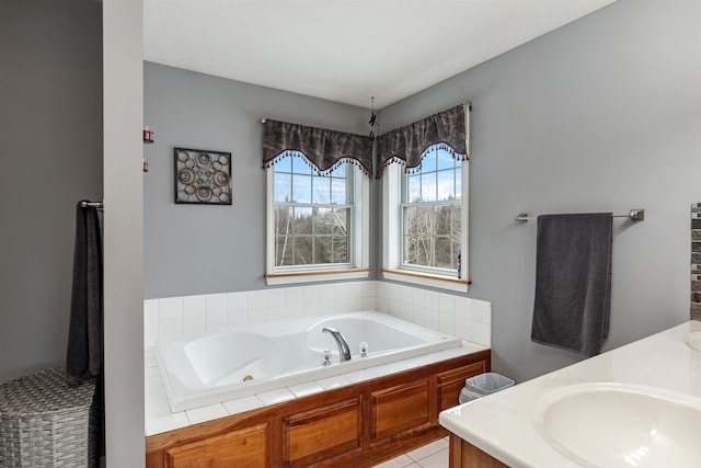 full bathroom featuring a jetted tub and vanity