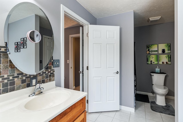 bathroom featuring tasteful backsplash, toilet, tile patterned floors, a textured ceiling, and vanity