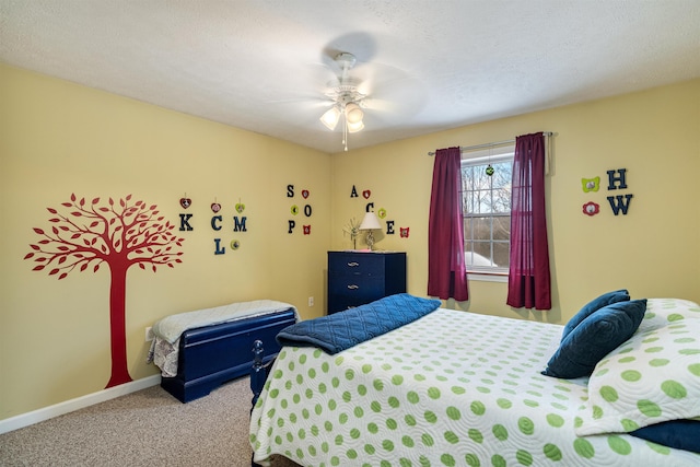 carpeted bedroom featuring a ceiling fan and baseboards