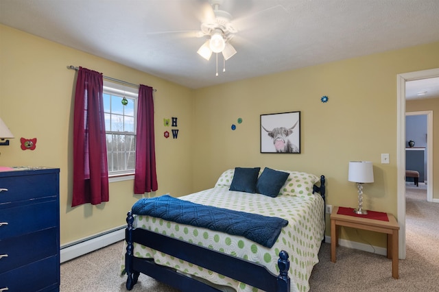 carpeted bedroom featuring a baseboard heating unit, a ceiling fan, and baseboards