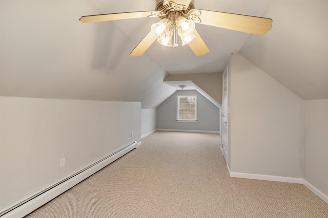 additional living space with lofted ceiling, baseboards, light carpet, and baseboard heating