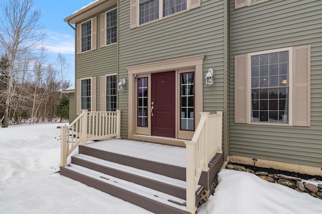 view of snow covered property entrance