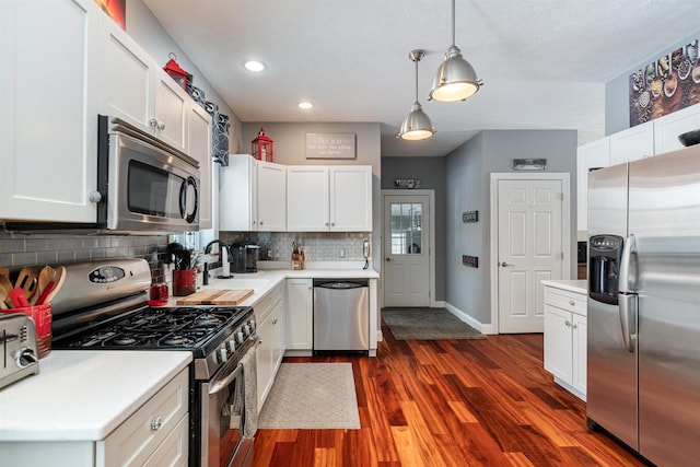 kitchen with tasteful backsplash, appliances with stainless steel finishes, and light countertops