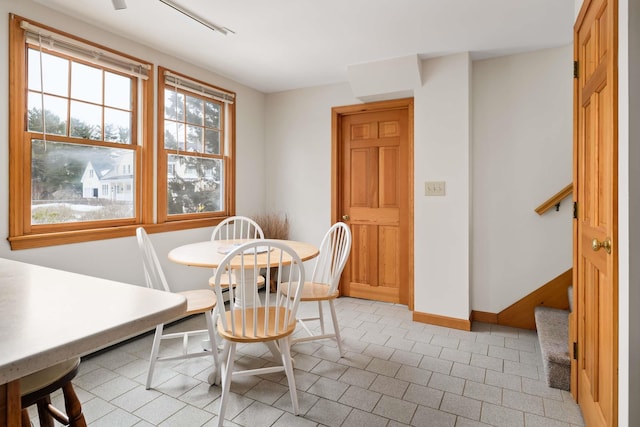 dining room with stairway and baseboards