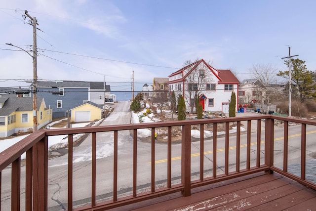 wooden deck with a garage and a residential view