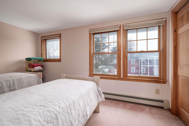 carpeted bedroom with baseboard heating