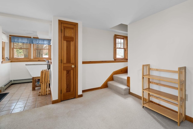 stairway with carpet, baseboards, baseboard heating, and tile patterned flooring