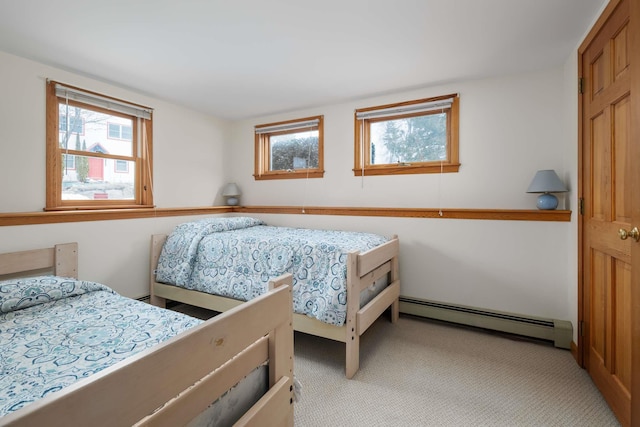 bedroom with light carpet and a baseboard radiator