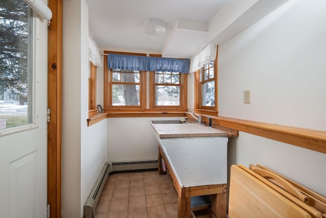 kitchen featuring a baseboard radiator and light tile patterned flooring