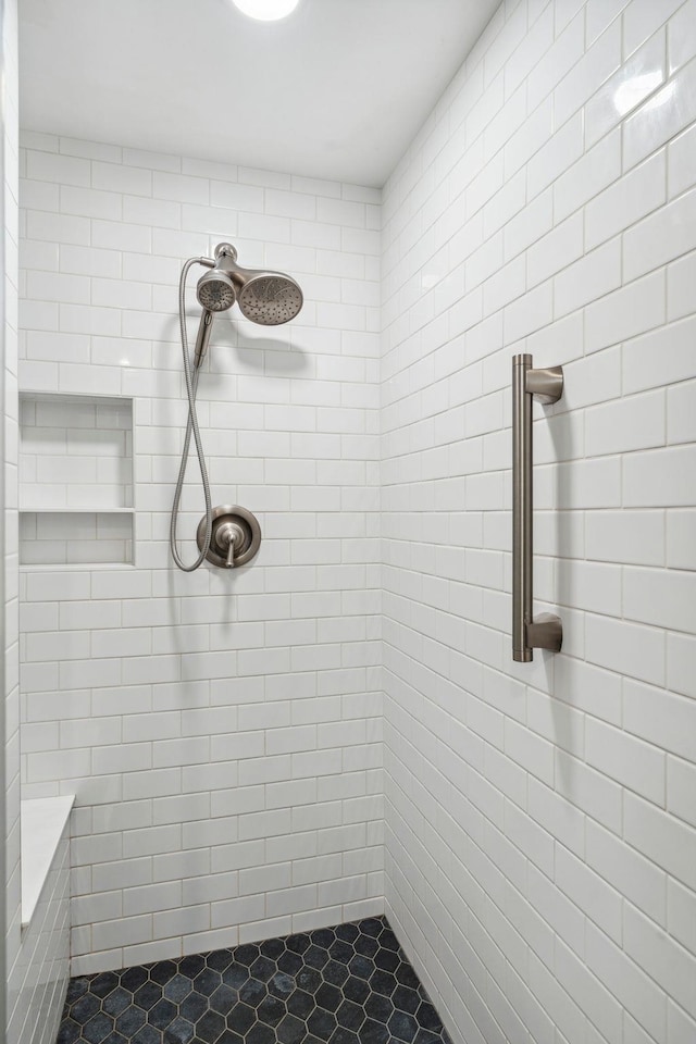 full bath featuring a tile shower