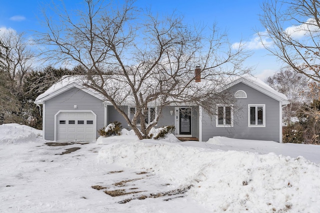 ranch-style house with a chimney and an attached garage