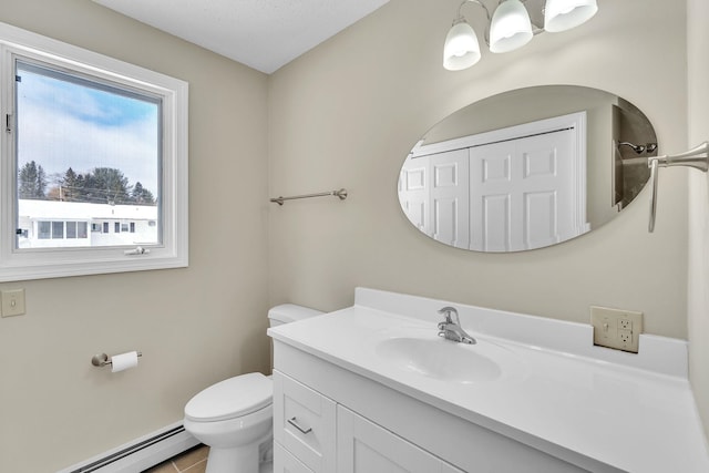 bathroom with baseboard heating, tile patterned flooring, vanity, and toilet