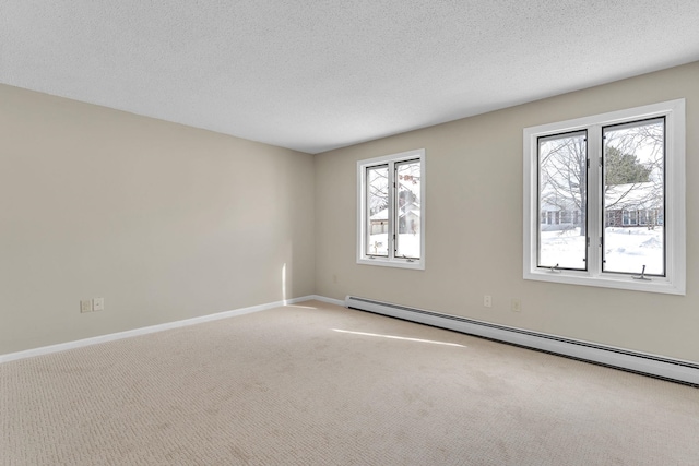 empty room with carpet floors, plenty of natural light, baseboards, and baseboard heating