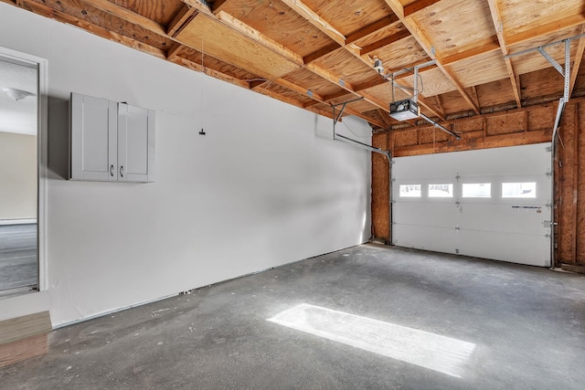 garage with a garage door opener and a baseboard heating unit