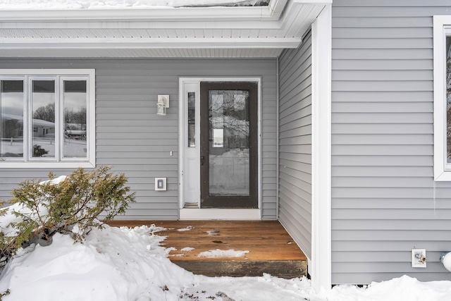 view of snow covered property entrance