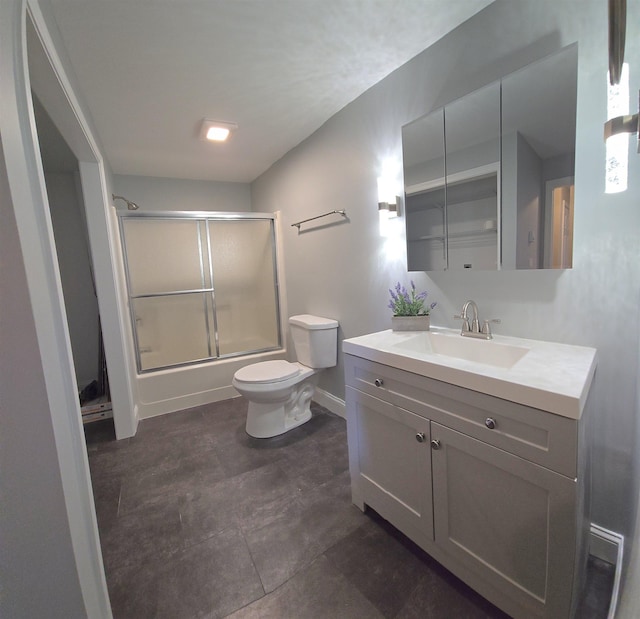 bathroom featuring shower / bath combination with glass door, vanity, toilet, and baseboards