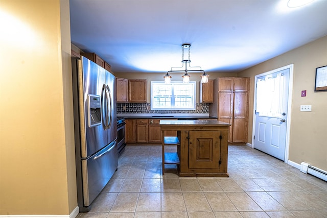 kitchen featuring backsplash, stainless steel refrigerator with ice dispenser, a wealth of natural light, and brown cabinetry