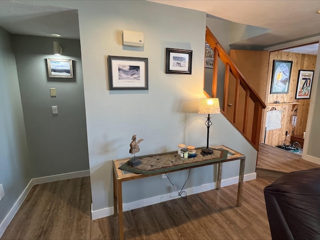 interior space with stairs, baseboards, and wood finished floors