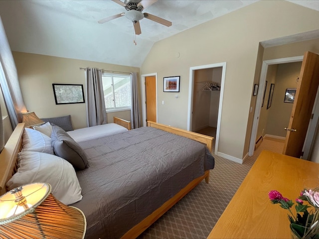 carpeted bedroom featuring baseboards, a ceiling fan, lofted ceiling, a spacious closet, and a closet