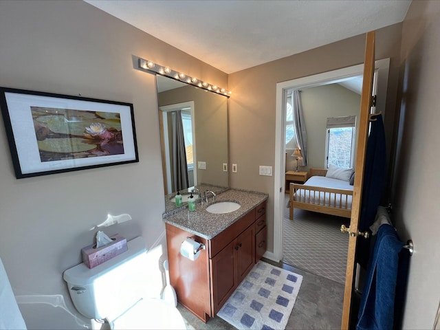 bathroom featuring ensuite bath and vanity