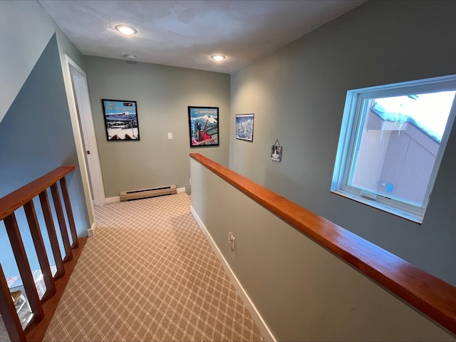 corridor featuring baseboards, an upstairs landing, a baseboard radiator, a textured ceiling, and carpet flooring