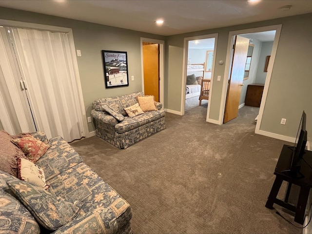 living room featuring recessed lighting, dark carpet, and baseboards