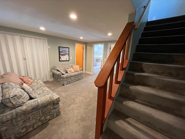 carpeted living area featuring stairs, baseboards, and recessed lighting