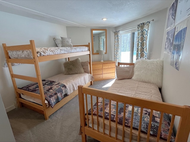 bedroom featuring a textured ceiling and carpet floors