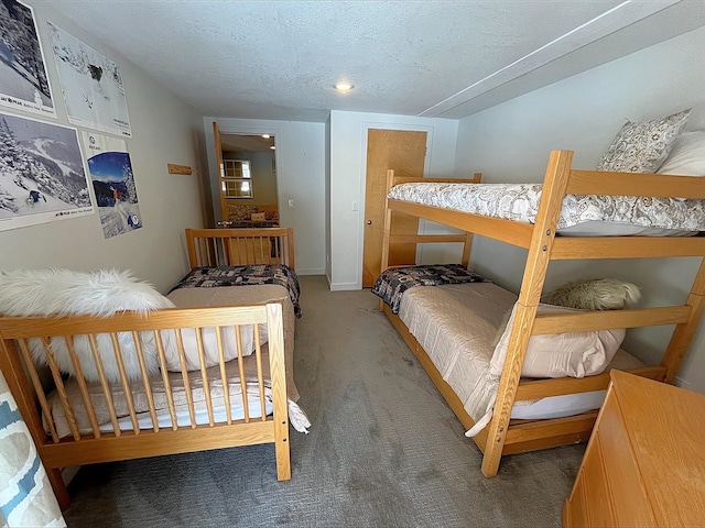 bedroom with carpet floors and a textured ceiling